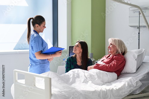 Nurse discussing care plan with patients in hospital room during afternoon hours