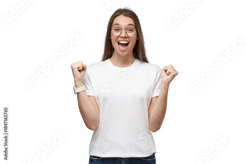 Excited woman celebrating victory and acting as if she is winner, clenches her fists and cheers with an open mouth