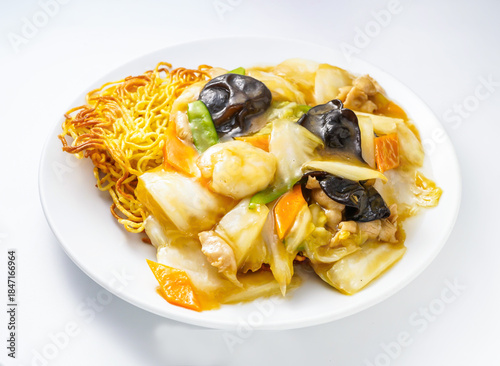 Delicious stir fry noodles with shrimp and vegetables on a plate