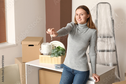 Young woman with key in ren...