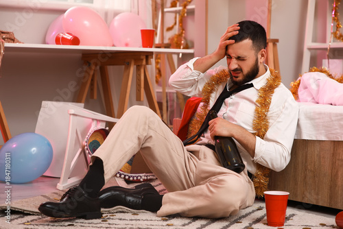 Canvastavla Young man with hangover sitting after Christmas party in bedroom