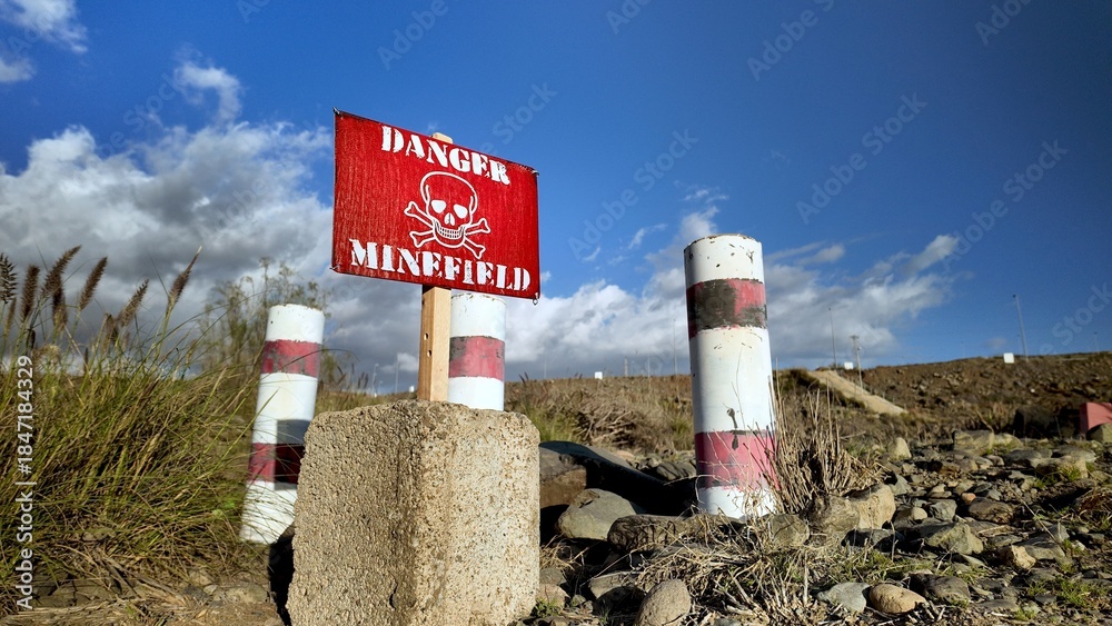 Αυτοκόλλητο Red danger sign with skull-and-crossbones warning marks hazardous minefield on d