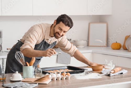 Young man preparing cookies...
