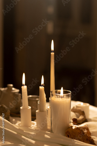 A collection of atmospheric lifestyle images featuring a minimalist beige interior with a cozy sofa, vinyl record player setup, and an elegant table decorated with numerous burning white candles