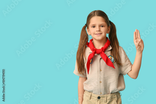 Little girl scout showing s...