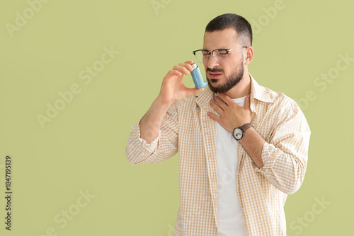 Young man with inhaler havi...