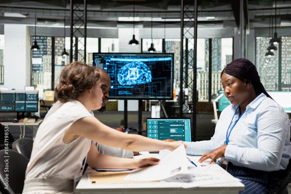 Obraz premium HR staff members using AI tech platforms and deep learning algorithms to analyze CV resumes and help with selecting candidates to fill in corporate vacancy. Workforce potential.