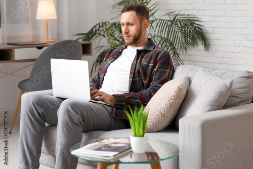 Handsome bearded man using ...