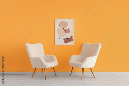 White armchairs and picture...