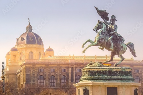 The equestrian statue of the Archduke Charles and the Museum of Natural History dome during a sunset in Vienna, Austria