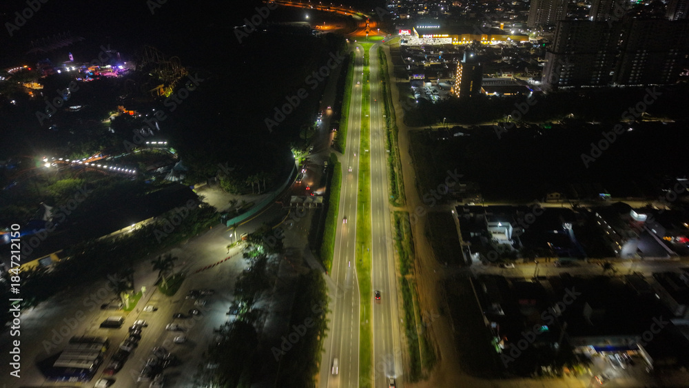 Obraz premium penha, santa catarina, brazil. 12.15.2025. An aerial view of a vibrant cityscape at night, with illuminated roads and buildings