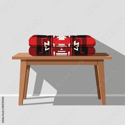 Stacked fire-resistant fire blankets neatly arranged on a wooden table in a minimalist setting