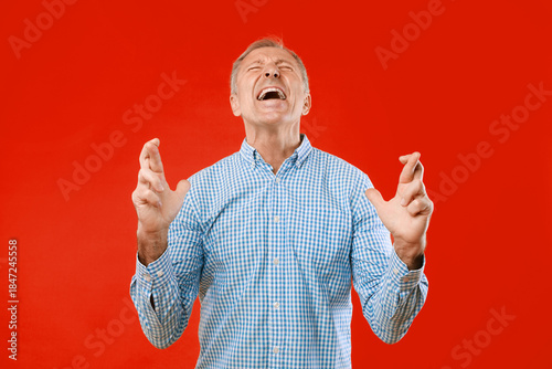 фотографія A man in a blue checkered shirt shows a clear sign of frustration