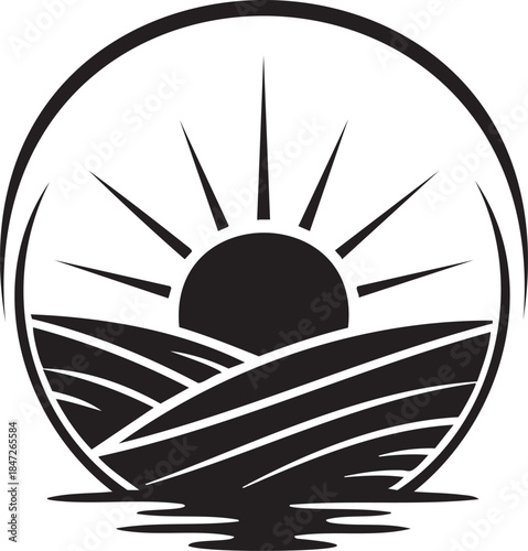 Black silhouette of sun rising over rolling hills and water