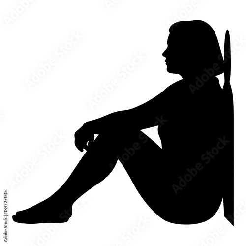 Silhouette of a thoughtful woman leaning against a wall in a relaxed posture
