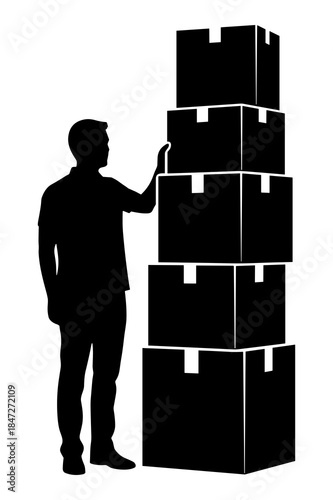 Silhouette of man standing next to a tall stack of moving cardboard boxes