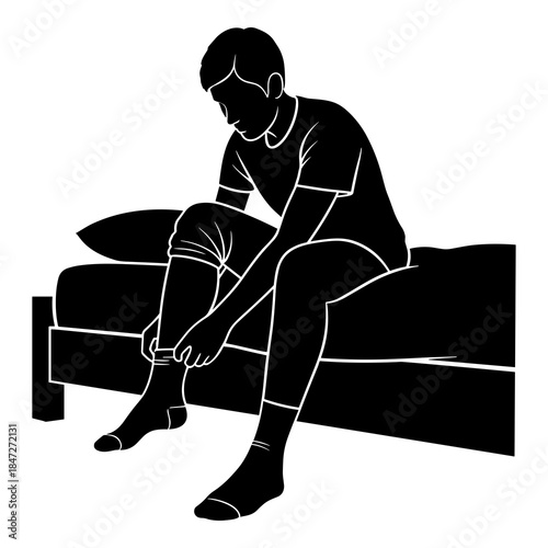 Person sitting on bed putting on socks preparing for morning activity or exercise