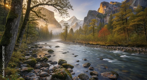 Majestic mountain valley scenery features a flowing river bordered by moss-covered trees and rocks