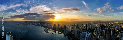 Fotografija Wide panoramic aerial view of the Panama City skyline and bay silhouetted agains