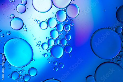 Close up of oil drops on water surface. Colorful abstract macro background of oil drops on water surface with air bubbles inside. Colorful background for gadget and computer wallpaper