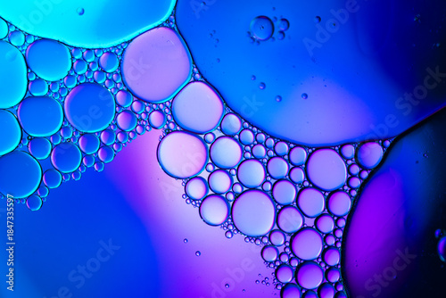 Close up of oil drops on water surface. Colorful abstract macro background of oil drops on water surface with air bubbles inside. Colorful background for gadget and computer wallpaper
