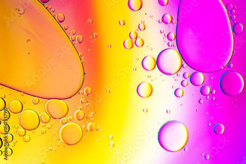 Close up of oil drops on water surface. Colorful abstract macro background of oil drops on water surface with air bubbles inside. Colorful background for gadget and computer wallpaper