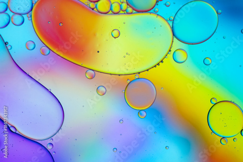 Close up of oil drops on water surface. Colorful abstract macro background of oil drops on water surface with air bubbles inside. Colorful background for gadget and computer wallpaper