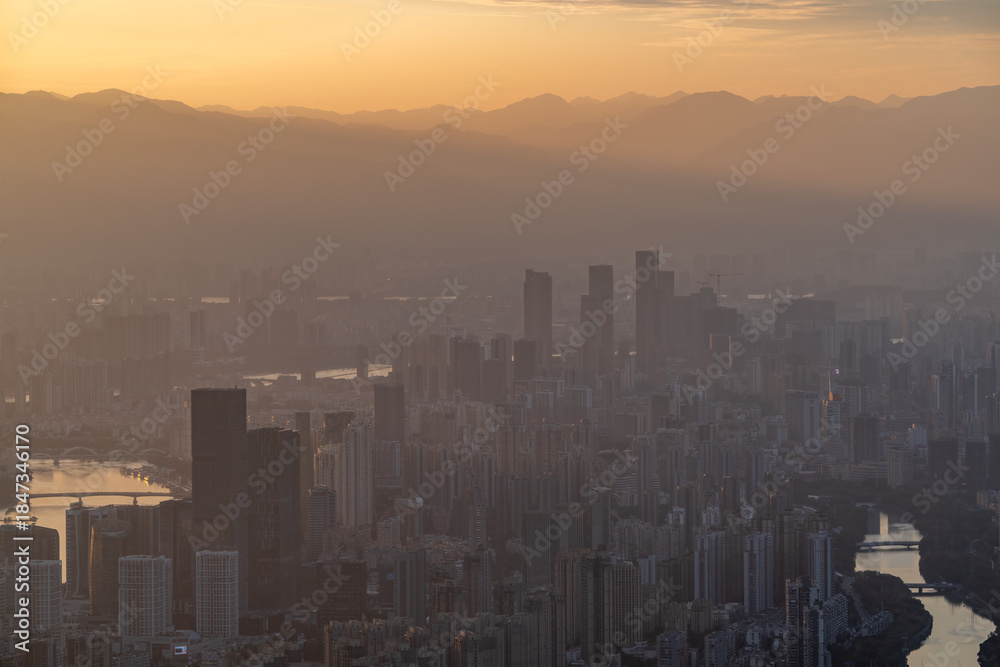 Fototapeta premium Sunset Over Urban Skyline with Skyscrapers