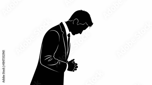 Silhouette of a businessman bowing his head in respect.