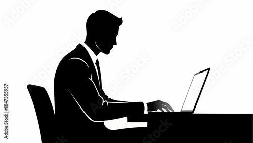 Silhouette of a businessman working diligently on his laptop computer in an office setting.