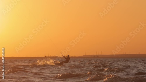 Kitesurfer performing high jump over sea tropical paradise sunset golden light freedom happiness lifestyle commercial vacation summer vibes exotic holiday adventure travel destination inspiration