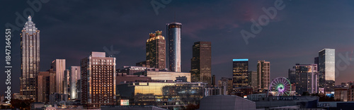 View of the Atlanta skyline showing several prominent buildings, hotels, office towers at night following sunset
