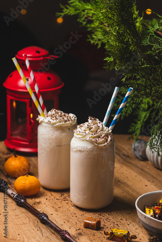 Glasses of butterbeer with a cap of whipped cream