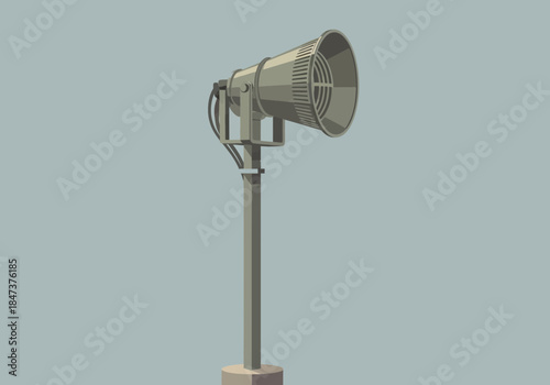 A metallic siren mounted on a pole with a speaker.