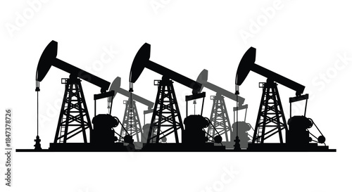 A striking view of oil pumps in a field presented as a dark silhouette