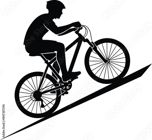 Silhouette of a mountain biker riding uphill