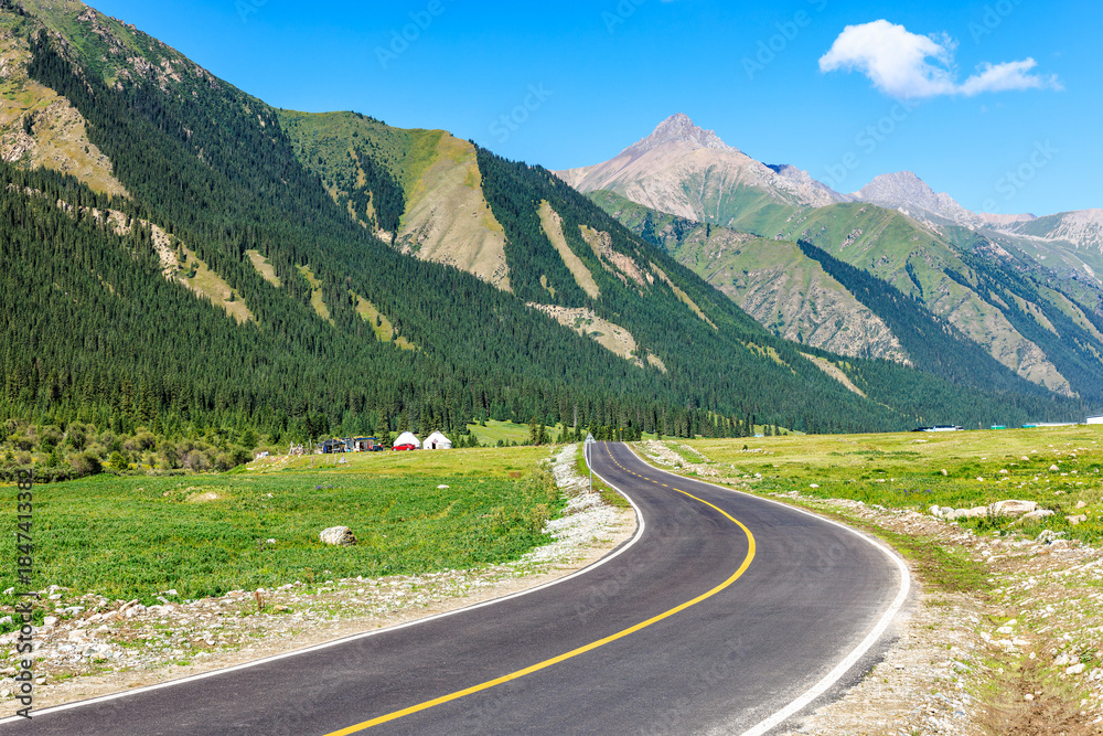 Fototapeta premium Winding asphalt road and green mountain natural landscape in summer