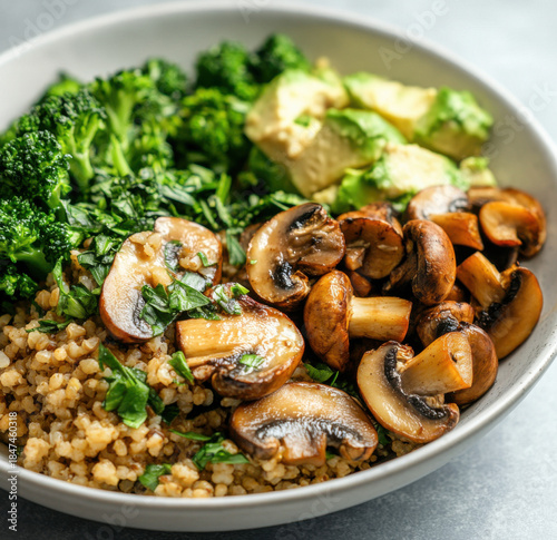 Mushroom Protein Grain Bowl With Broccoli, Brown Rice, And Greens On White Plate
