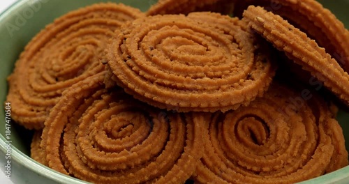 Chakli is a savoury snack from India. It is a spiral shaped snack with a spiked surface