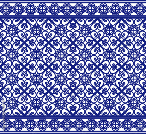 Elegant blue and white seamless ornamental tile pattern with symmetrical floral motifs and decorative borders. Ideal for wallpapers, textiles, ceramics, packaging and classic interior design.