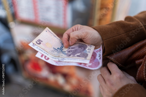 Fototapeta Naklejka Na Ścianę i Meble -  Hand holding turkish lira banknotes for tourism expenses