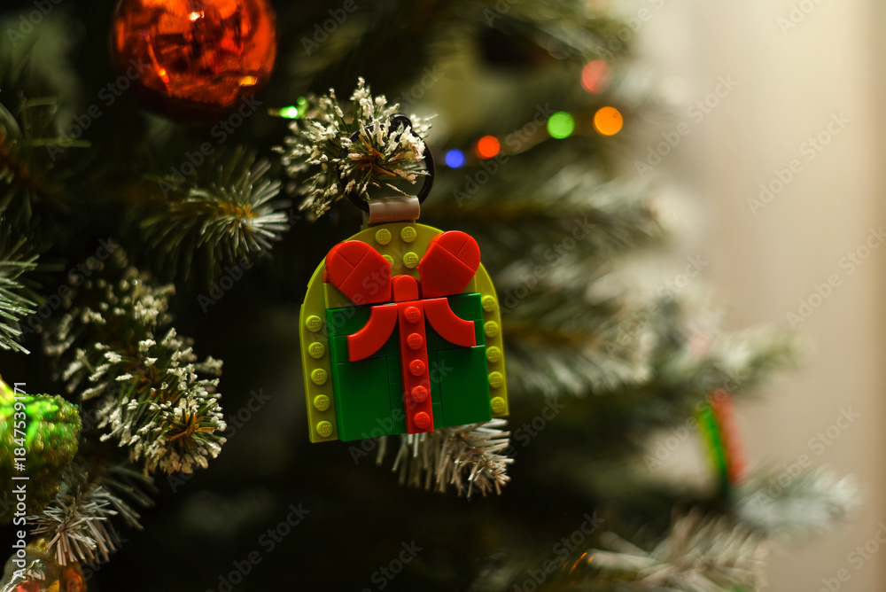Fototapeta premium A Lego Christmas gift on a Christmas tree branch.