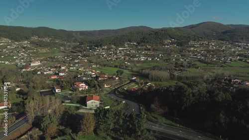 Approaching the charming town of Arouca in Northern Portugal. Aerial shot flying towards the city center, showcasing the peaceful atmosphere and surrounding nature