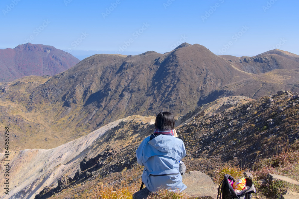Fototapeta premium 大分県のくじゅう連山、星生山で休憩するハイカー