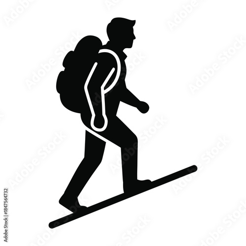 Trekker silhouette walking up trail slope