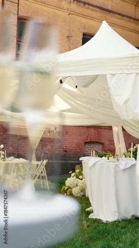 A very beautiful and stylish banquet table with a tent outdoors. Wedding decor and floral arrangements before the ceremony and celebration