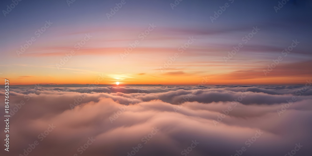 Obraz premium A breathtaking view above the clouds at sunset showcasing vibrant orange hues