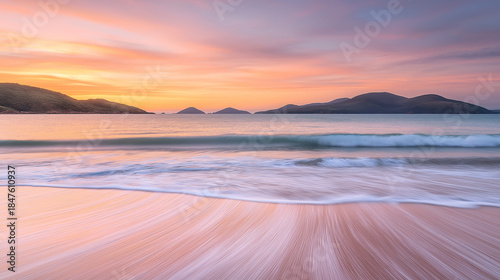 Pastel Sunset Over Calm Ocean Waves and Sandy Beach