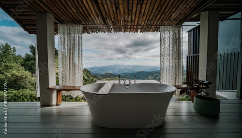 an outdoor bath at the balcony with scenery view of natural hills and mountains in open blue sky