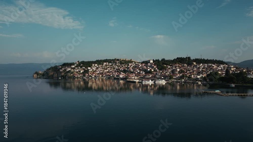 Drone view of the beautiful town of Ohrid on the lake with ferries docked, 4k